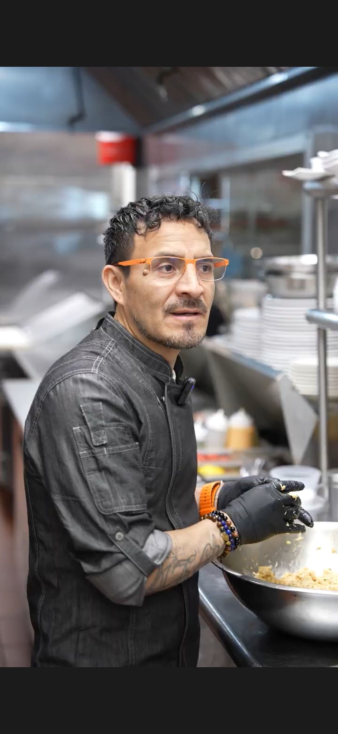 Executive Chef Braulio Bunay working in the River Dock kitchen, mid-service