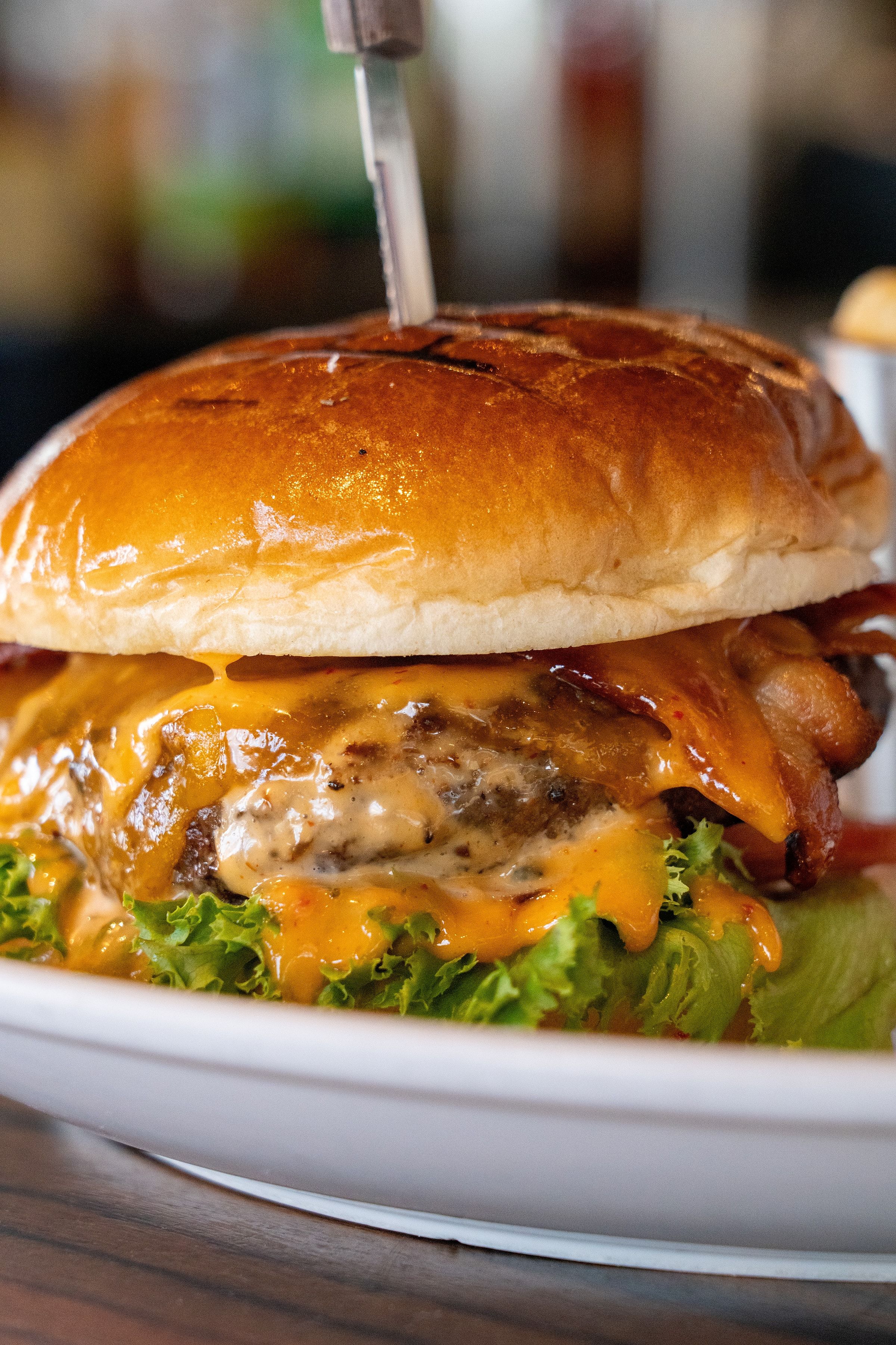River Dock wagyu burger with bacon and melted cheese on a brioche bun